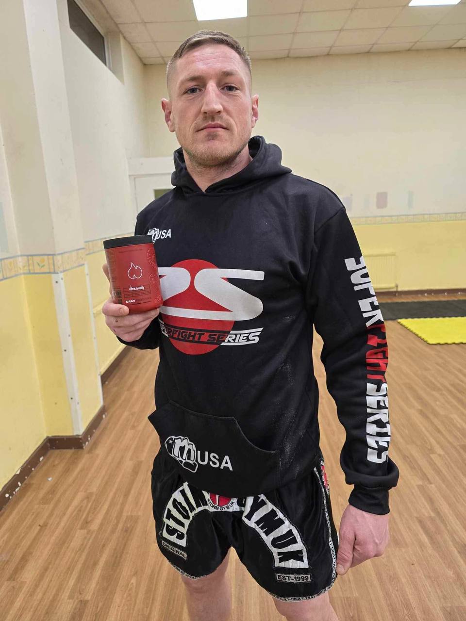 Kickboxing Champion Darren Anstey holding Firblood Supplement