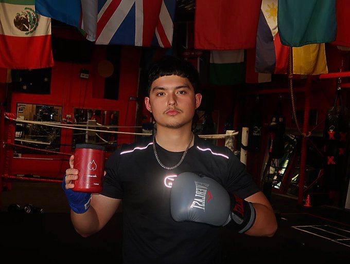 Young Boxer Holding Fireblood Supplement